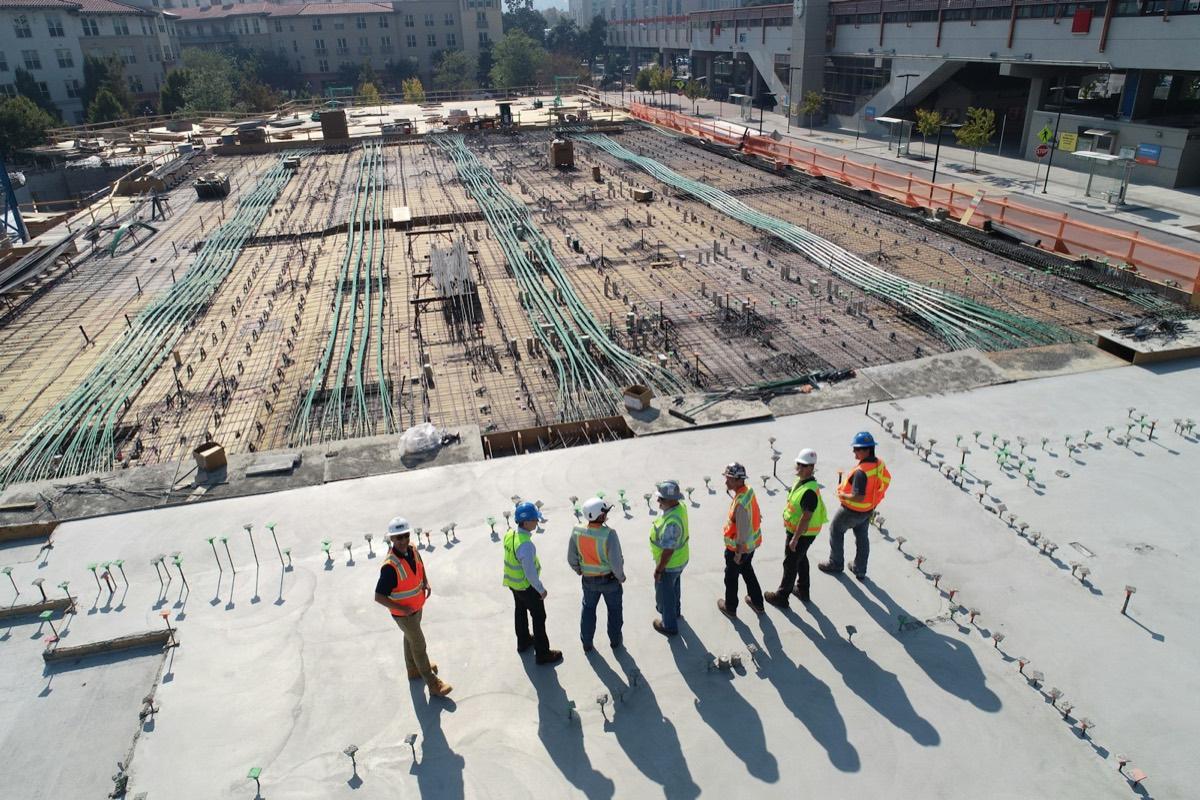 Commercial construction site with a project crew reviewing structural work